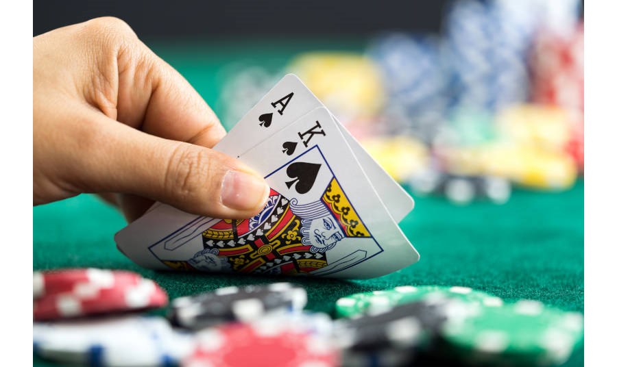 Person looking at two cards at a blackjack table